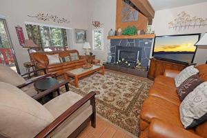a living room with a couch and a fireplace at 1240 Timber Lane home in South Lake Tahoe