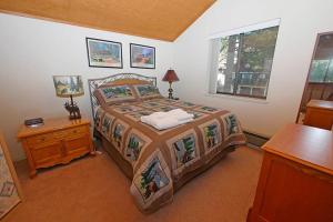 a bedroom with a bed and a table and a window at 1240 Timber Lane home in South Lake Tahoe