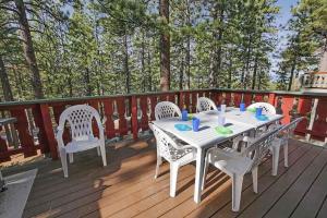 a white table and chairs on a wooden deck at 1240 Timber Lane home in South Lake Tahoe