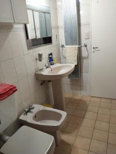 a bathroom with a toilet and a sink and a shower at LA CASA DE LA PARRA in Godoy Cruz
