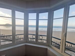 a room with windows with a view of the beach at Apartment Les Armateurs by Interhome in Saint Malo
