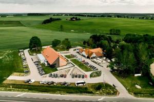 an aerial view of a building with a parking lot at Kozi Dwór - Sielanka in Gietrzwałd
