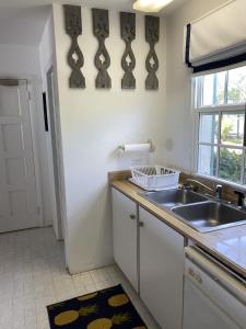 a kitchen with a sink and a counter top at Treasured villa in Savannah Sound