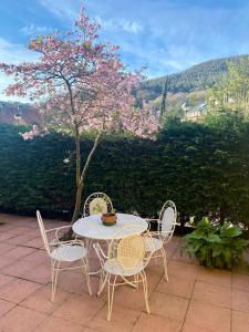 a table and chairs on a patio with a tree at La casita del Pisueña in La Cueva