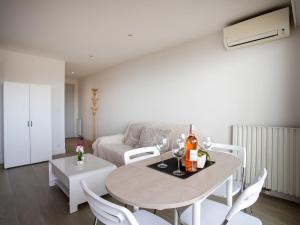a living room with a table and chairs and a couch at Studio Le Cagnes Beach-1 by Interhome in Cagnes-sur-Mer