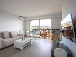 a living room with a couch and a table at Studio Le Cagnes Beach-1 by Interhome in Cagnes-sur-Mer