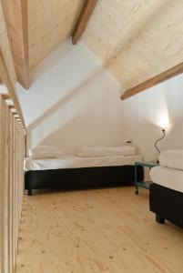 a bedroom with two beds in a attic at Vakantieverblijf de Trommel in Domburg