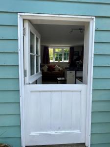 a white garage door with a view of a living room at Rural Retreat in Idyllic Countryside - fishing & walks in Hawkhurst