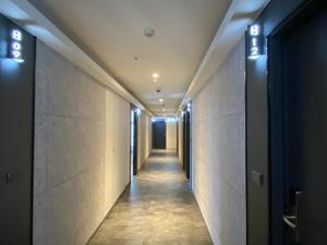 a corridor of an office building with lights on the ceiling at Hub Hotel Songshan Inn in Taipei
