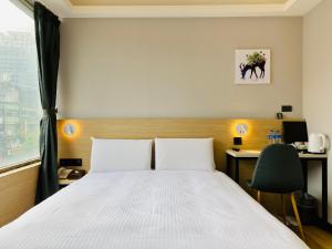 Llit o llits en una habitació de Hub Hotel Songshan Inn