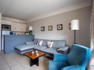 a living room with a couch and a table at Apartment Heliotel Marine by Interhome in Saint-Laurent-du-Var