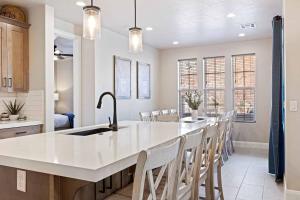 a kitchen with a large white island with a sink at Escondido Cove in Washington