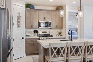 a kitchen with wooden cabinets and a kitchen island at Escondido Cove in Washington