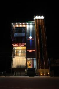 a building with lights on top of it at night at Sunshine International Boarding & Lodging in Belūr