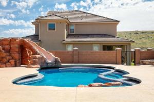 a swimming pool with a water slide in front of a house at Zion Reunion Poolhouse home in Washington +57 photos