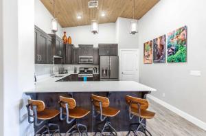a kitchen with a large island with bar stools at The Penthouse S402 condo in St. George