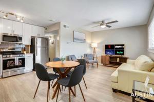 a kitchen and living room with a table and chairs at Remodeled Apt w Gated Community and In-Unit Laundry in Austin