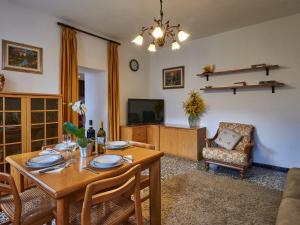 a living room with a table and a television at Holiday Home Casa Pina by Interhome in Porlezza
