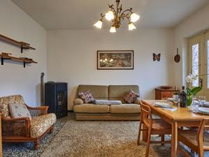 a living room with a couch and a table at Holiday Home Casa Pina by Interhome in Porlezza