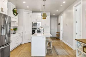 a white kitchen with a sink and a refrigerator at The Pearl at Desert Shores townhouse in St. George