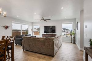 a living room with a couch and a tv at The Bend at Paseos in Washington