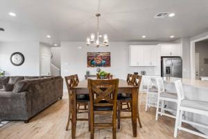 a kitchen and dining room with a table and a couch at The Bend at Paseos in Washington +35 photos