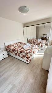 a bedroom with two beds and a mirror at Da Enzo in Desenzano del Garda
