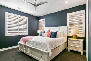 a bedroom with blue walls and a bed with pillows at Desert Moose #75 townhouse in Santa Clara +51 photos