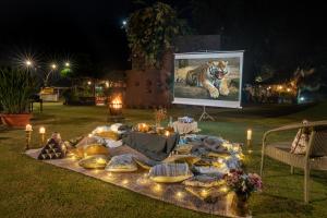 a table with a picture of a tiger on a screen at LohonoStays Homestead, Corbett in Rāmnagar