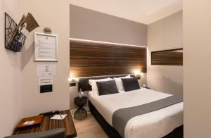a hotel room with a bed and a table at Aiello Hotels - Duomo in Milan