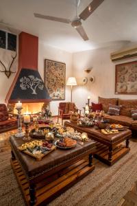 a living room with two tables filled with food at LohonoStays Homestead, Corbett in Rāmnagar