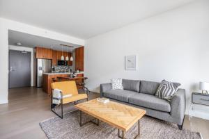 a living room with a couch and a table at Downtown 1BR w Gym Pool nr Disney Concert Hall LAX-372 in Los Angeles