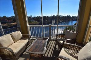 a balcony with chairs and a couch and a table at 332 Edgewater Villa in Myrtle Beach