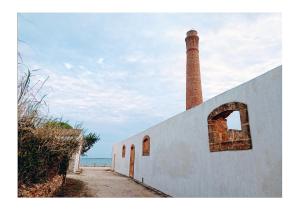 a building with a brick tower on top of it at La Corte di Vincenzo in Noto