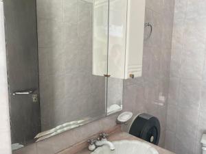 a bathroom with a sink and a mirror at Nomada Hostel Oaxaca - Vive nómada! in Oaxaca City