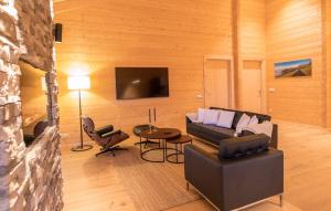 a living room with a couch and a table at NETTEN Naturerlebnis Holz-Chalets in Daun
