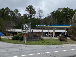 a walmart gas station with a sign in front of it at JI10, a Queen Guest Room at the Joplin Inn, at the entrance to Mountain Harbor Resort Hotel Room in Mount Ida