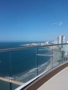 a view of the ocean from the balcony of a building at Apartamento frente a la playa in Cartagena de Indias