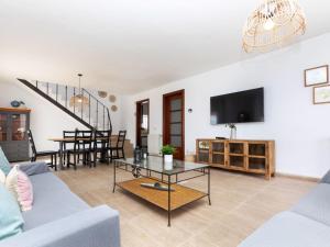 een woonkamer met een bank en een tafel bij Villa Neus by Interhome in Lloret de Mar