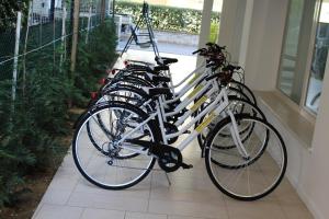 a row of bikes parked next to a wall at Hotel Massimo in Riccione