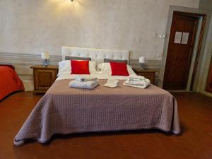 a bedroom with a large bed with towels on it at B&B i Rinascimenti in Florence