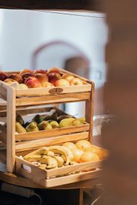 two wooden baskets filled with apples and other fruits at Hotel Bären in Feldkirch