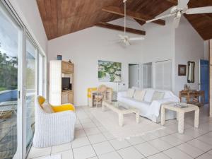 uma sala de estar com um sofá e uma mesa em Pebbles cottage em Governorʼs Harbour