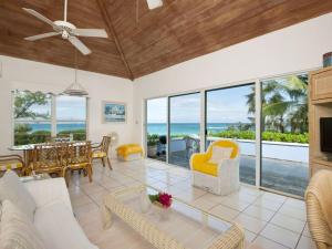 a living room with a view of the ocean at Pebbles cottage in Governorʼs Harbour