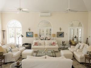 a living room with white furniture and white walls at Coriolana home in Savannah Sound