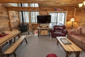 a living room with a couch and a tv in a cabin at Seven Springs - Swiss Mountain 3 Bedroom Standard Condo, Near Golf Course condo in Champion