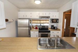 a kitchen with a sink and a stainless steel refrigerator at Seven Springs - Swiss Mountain 3 Bedroom Standard Condo, Near Golf Course condo in Champion