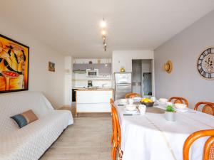 a living room with a table and a couch at Apartment Les Coraux by Interhome in Agay - Saint Raphael