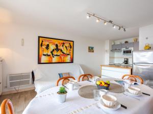 a kitchen and a dining room with a table and chairs at Apartment Les Coraux by Interhome in Agay - Saint Raphael