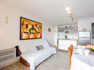 a living room with a couch and a kitchen at Apartment Les Coraux by Interhome in Agay - Saint Raphael